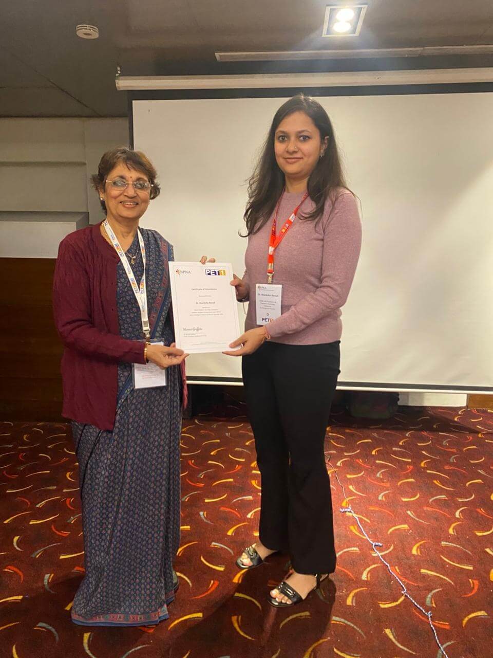 Dr. Bansal receiving a certificate of attendance at a British Paediatric Neurology Association PET1 course