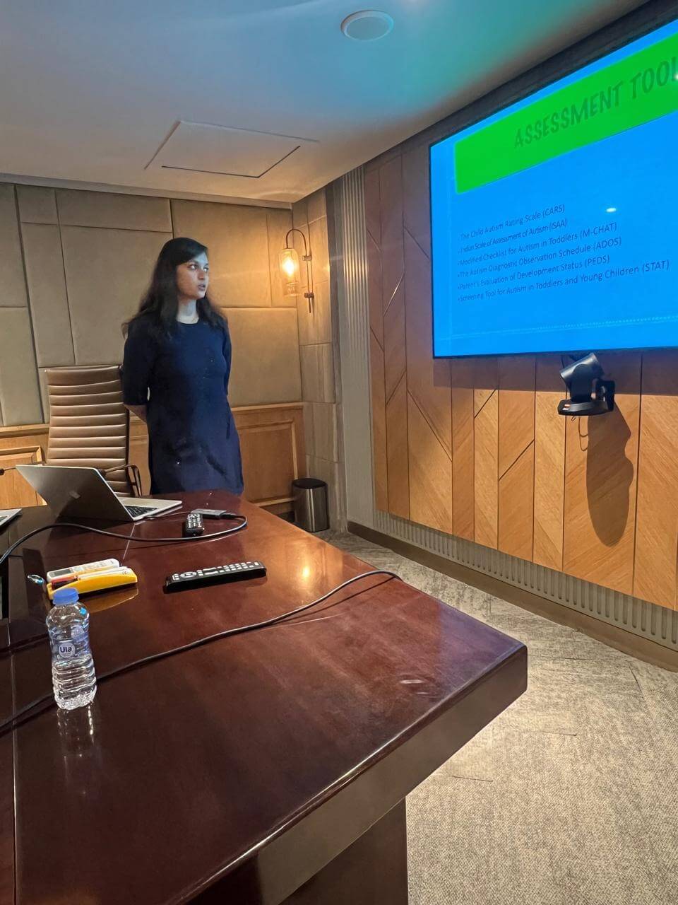 Dr. Bansal presenting a slide listing autism assessment tools, including CARS, ISAA, M-CHAT and ADOS